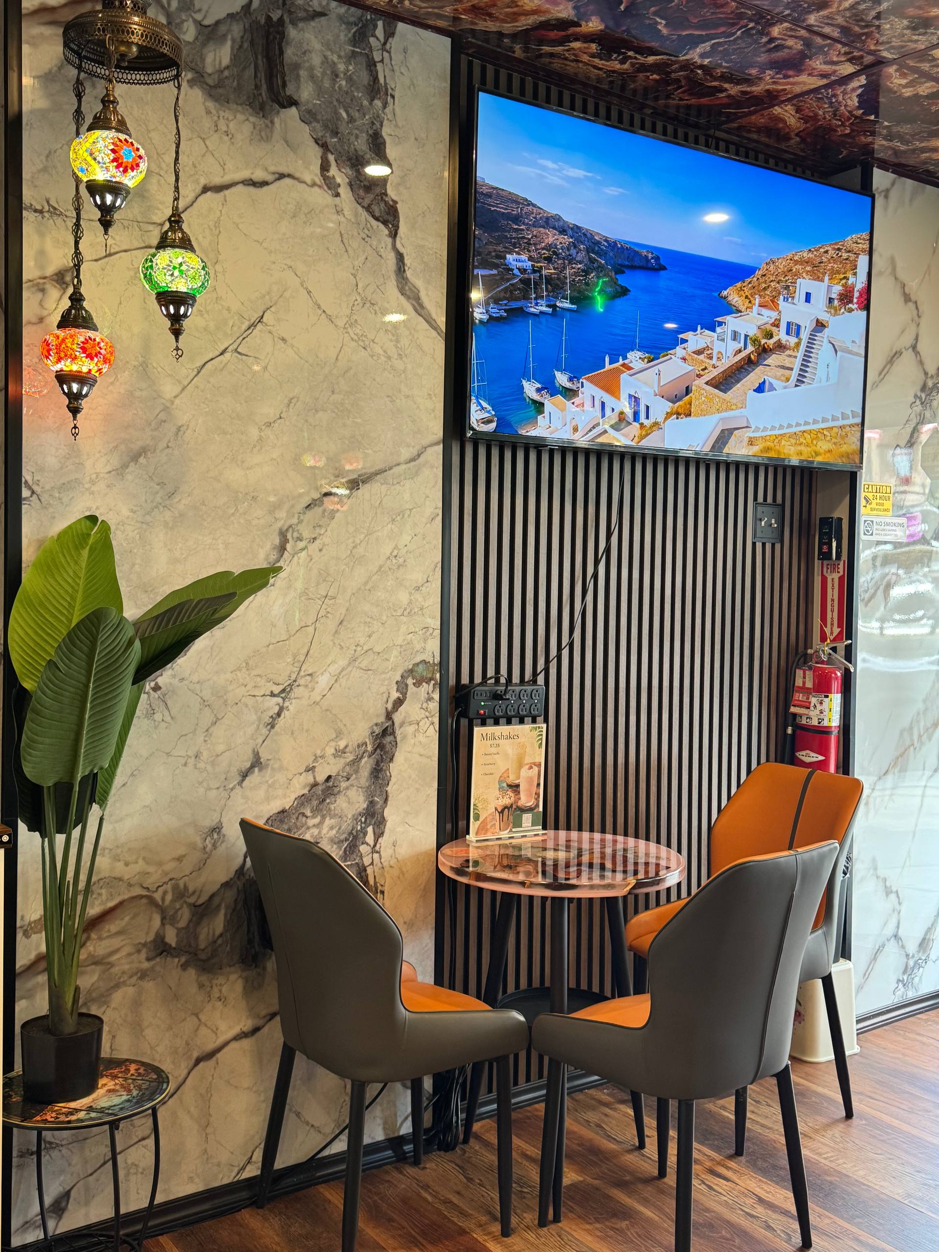 A quiet Coffeeccino table for two beneath colorful lamps